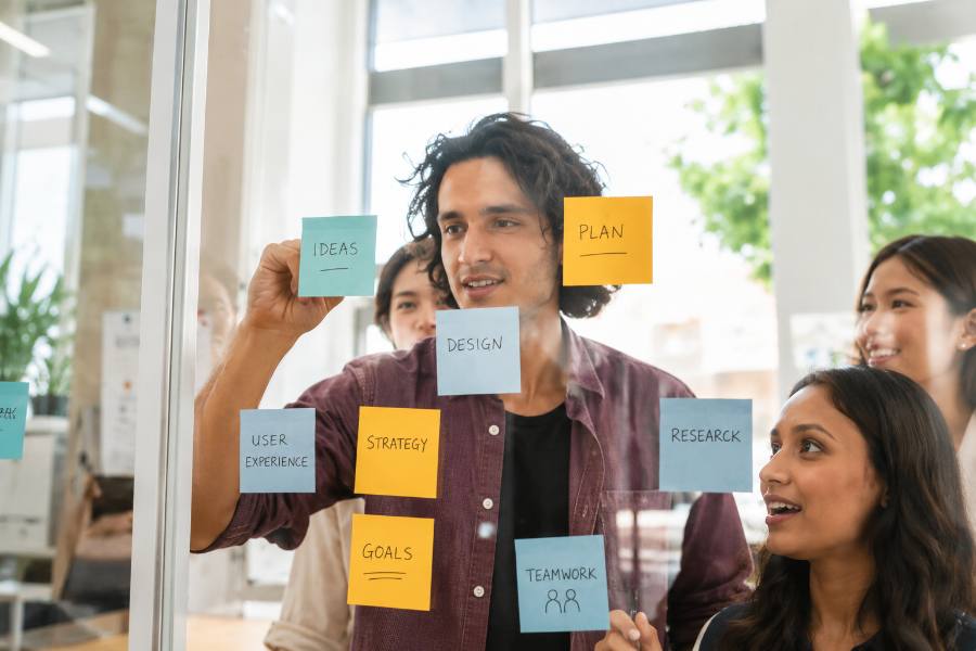 Team brainstorming design thinking process on sticky notes
